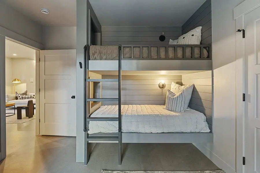 Matterhorn Hygge House built-in bunk beds with shiplap walls and industrial pipe ladder