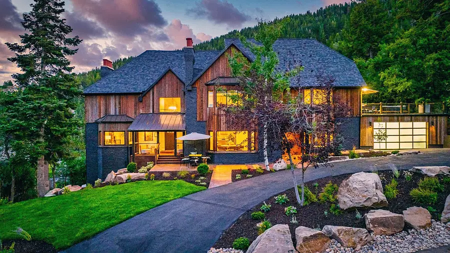 Matterhorn Hygge House twilight facade with landscaped driveway and illuminated garage