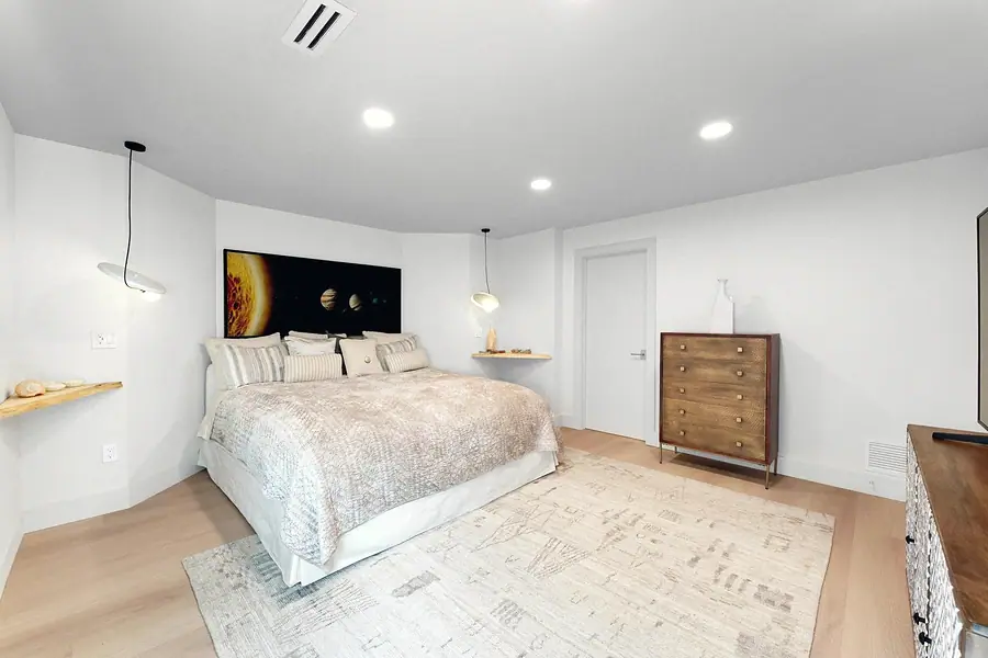 Elysium bedroom with solar system headboard art and neutral bedding