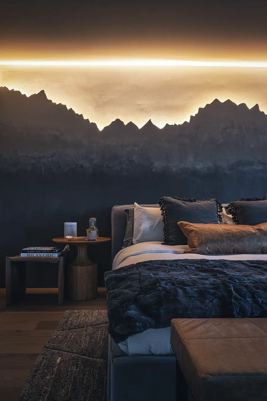 Matterhorn Hygge House bedroom detail with LED mountain wall, fur throw, and wood nightstands