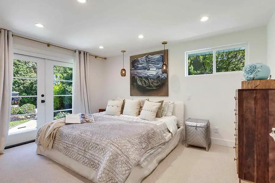 Wallace Project primary bedroom with French doors and soft neutrals