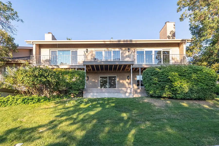 Crista da Montanha rear elevation with upper deck, lawn, and mature landscaping