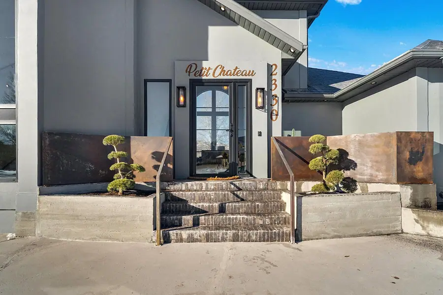 Front entry steps with Petit Chateau script signage and copper side panels