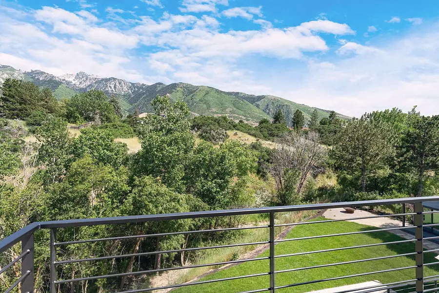 Elysium deck view of Wasatch mountains, trees, and lawn below