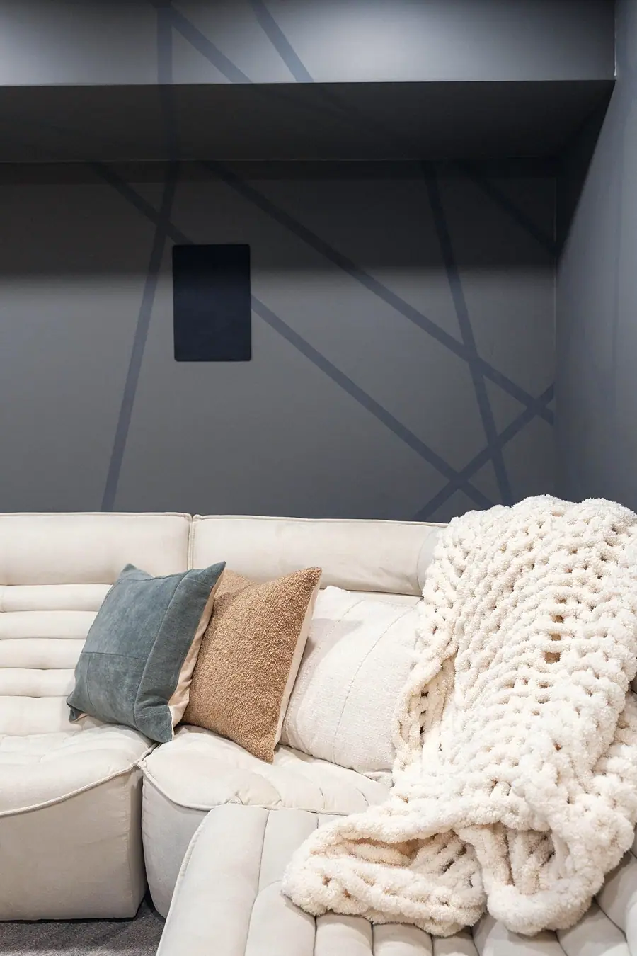 Midway lounge seating detail with chunky knit throw and textured pillows