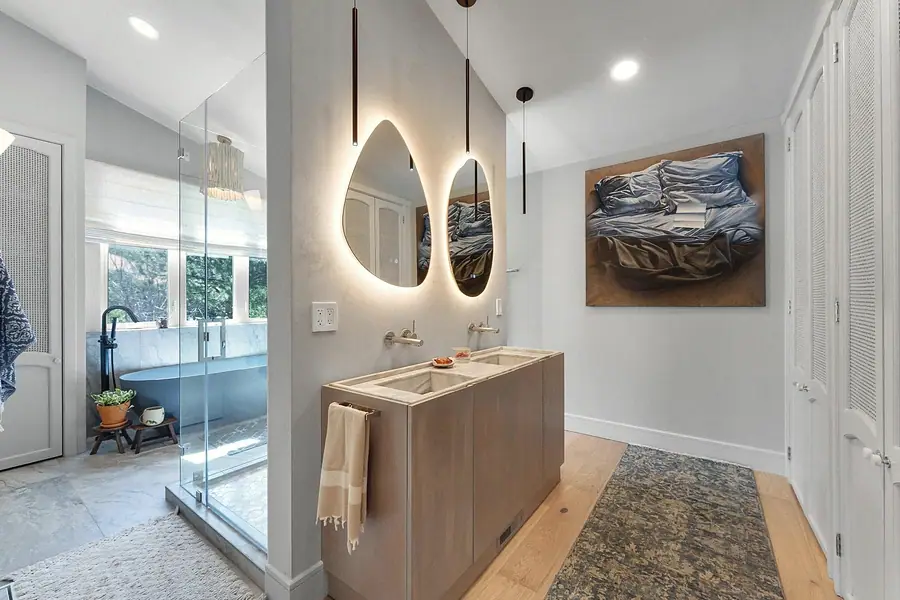 Elysium primary bath with dual organic mirrors, freestanding tub, and glass shower