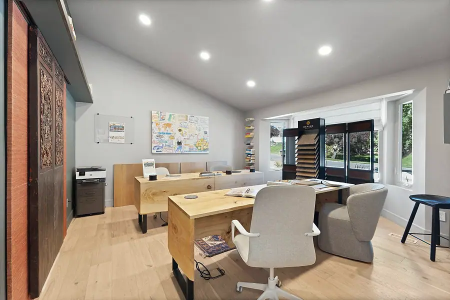 Elysium design studio office with live-edge wood desks, sample boards, and garden windows