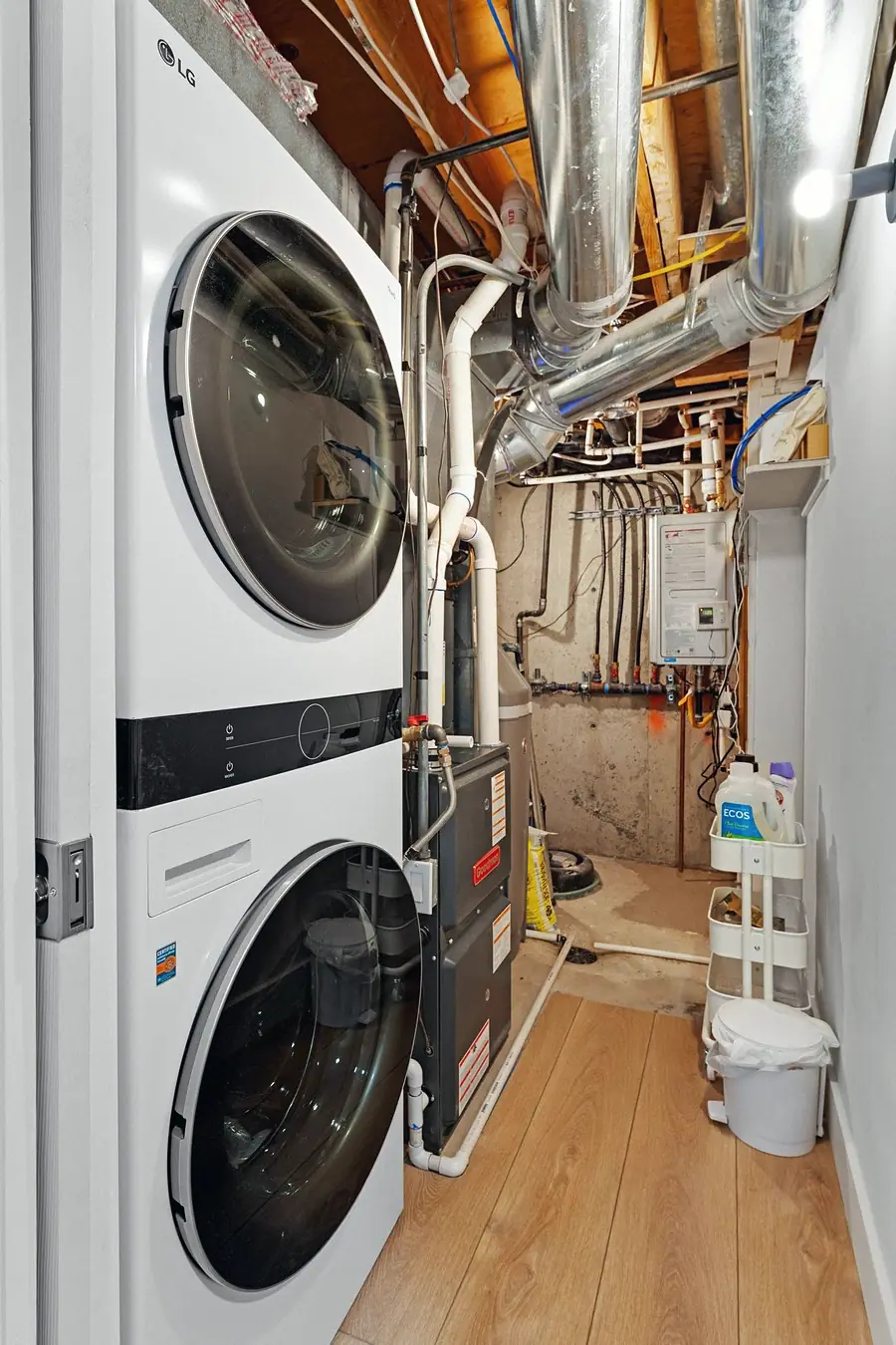 Midway laundry utility room with stacked LG washer dryer and mechanical systems