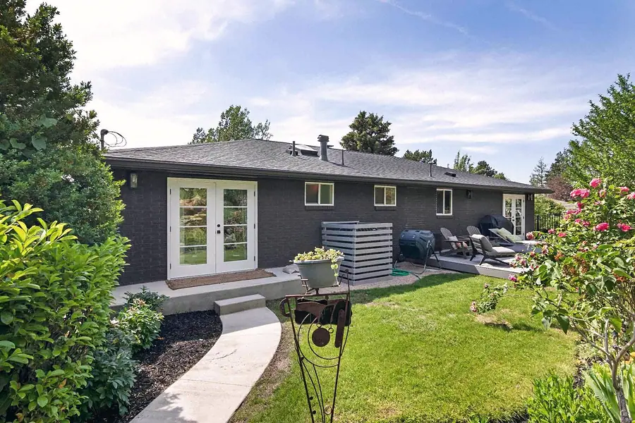 Wallace Project backyard elevation with white French doors and garden path