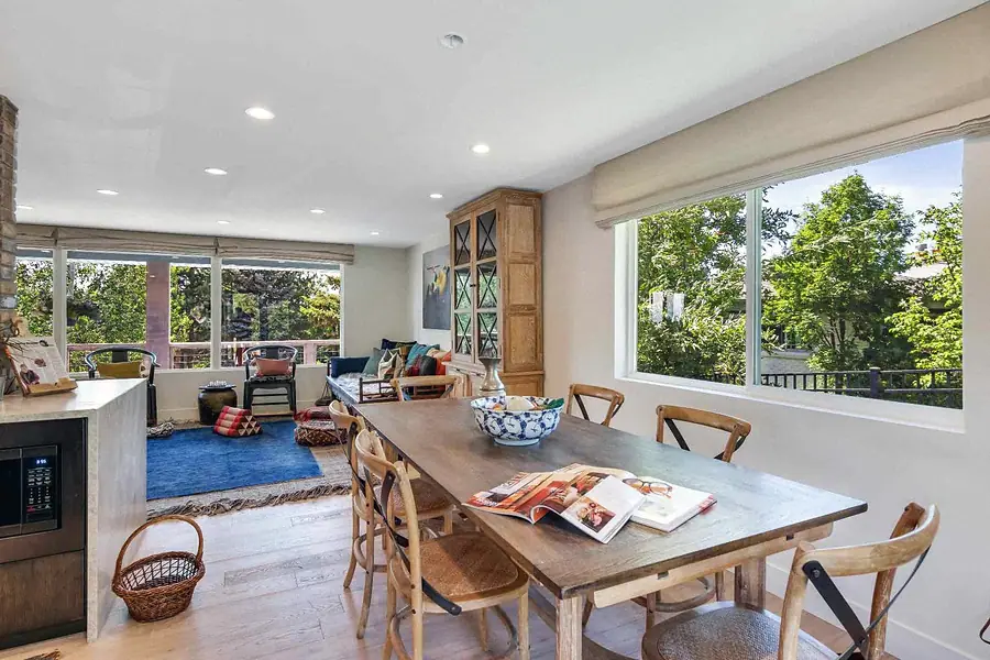 Wallace Project open dining and living area with blue rug and natural light