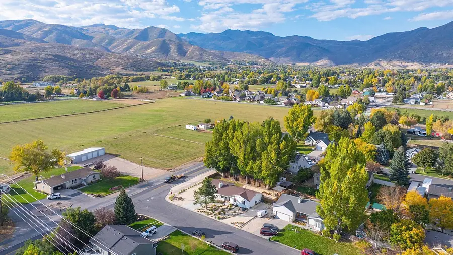 Aerial view of Midway vacation home neighborhood with fields and Wasatch mountains