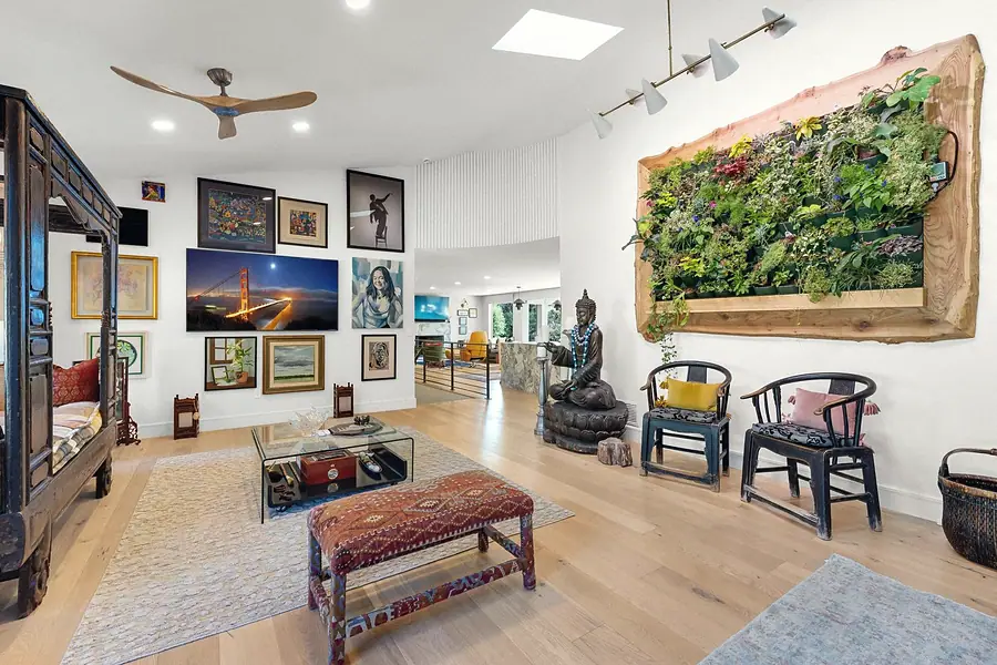 Elysium open living space with living plant wall, art gallery, and Chinese chairs