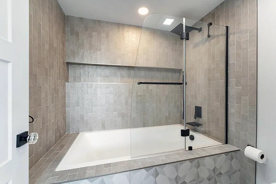 Fairway House bathroom with black marble double vanity and gold fixtures