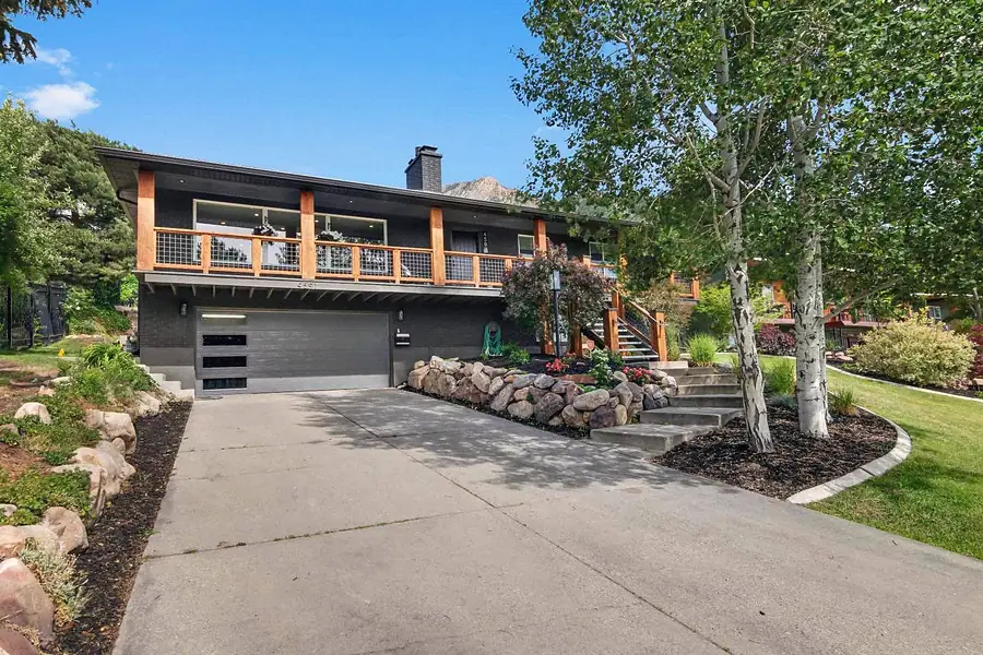 Wallace Project front exterior with garage, driveway, and mountain backdrop