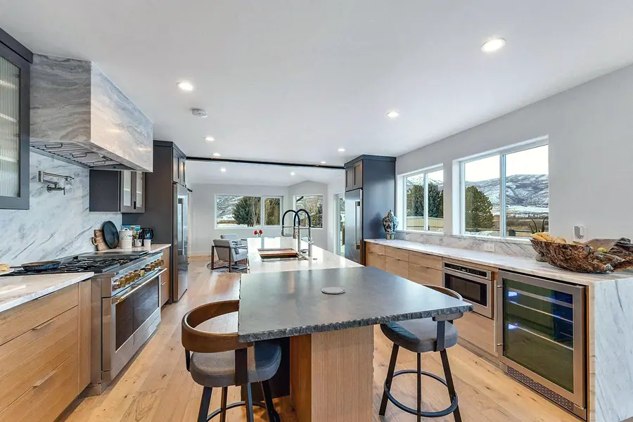 Kitchen island with mountain window views and professional range