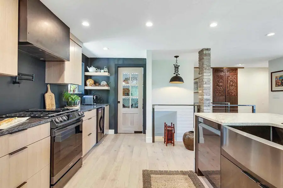 Wallace Project kitchen looking toward glass door and carved wood doors