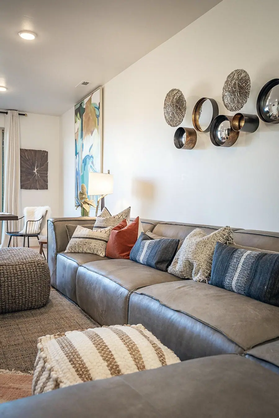 Silver Creek gray sectional with textured pillows and circular wall décor