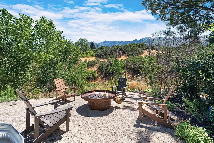 Elysium fire pit circle with Adirondack chairs and mountain views