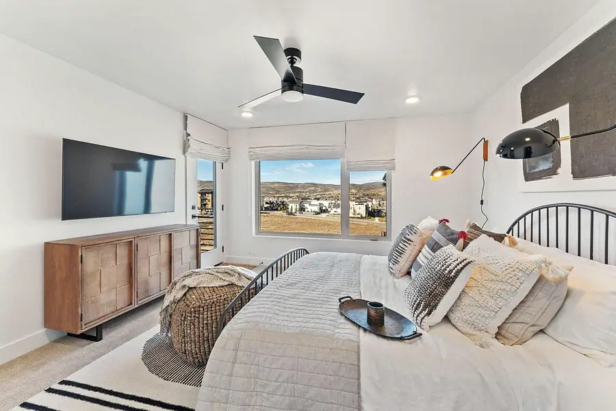 Silver Creek bedroom with mountain views, wood media console, and layered bedding