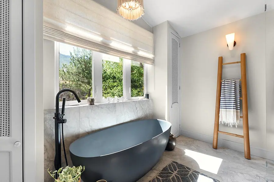 Elysium freestanding blue soaking tub with mountain window views