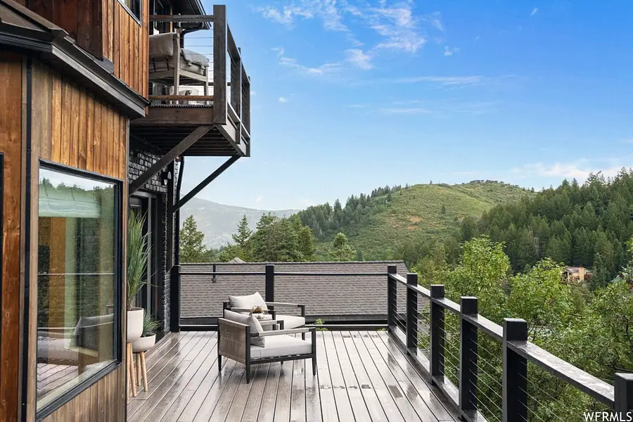 Matterhorn Hygge House deck lounge chairs overlooking green mountain hills