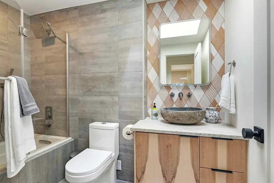 Wallace Project bathroom with stone vessel sink and glass shower